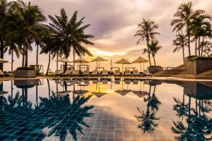 Beautiful luxury outdoor swimming pool in hotel and resort Beautiful luxury outdoor swimming pool with umbrella and chair in hotel and resort for travel and vacation